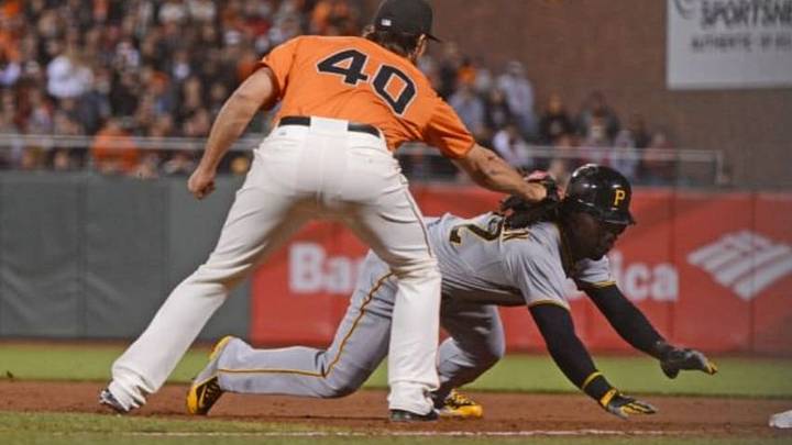 Pittsburgh Pirates center fielder Andrew McCutchen (22, back) is tagged out by San Francisco Giants starting pitcher Madison Bumgarner (40) on a caught-steal during the eighth inning at AT&T Park. Mandatory Credit: Kyle Terada-USA TODAY Sports